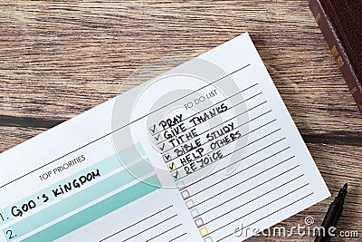 Handwritten Christian priorities (God's kingdom) and to-do list in notebook, prayer, bible study, tithing concept Stock Photo