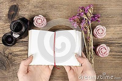 Handwritten diary: woman holding hardcover notebook Stock Photo