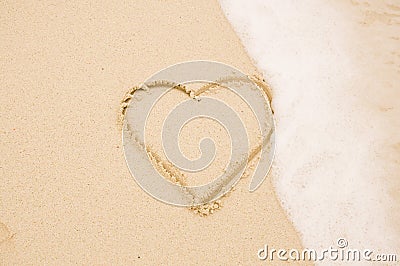 Handwritten heart on sand Stock Photo