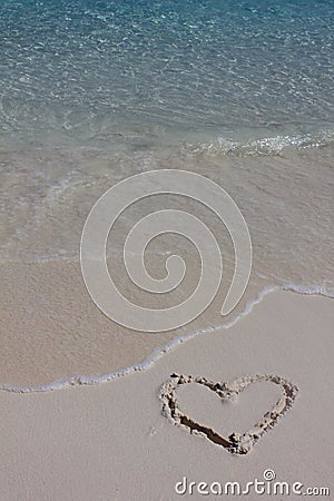 Handwritten heart on sand Stock Photo