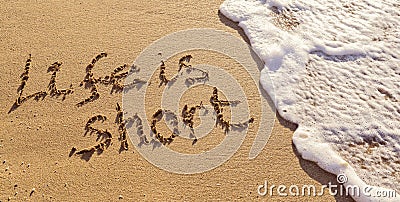 Handwritten inscription Life is Short on the sand with flushing foamy wave Stock Photo