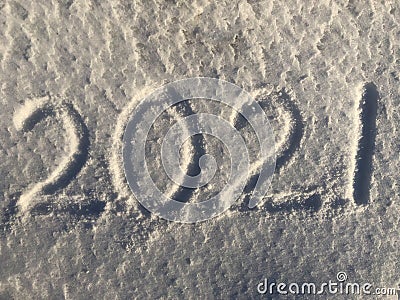 Handwritten inscription on snow 2021. Happy New Year. Background, white. Stock Photo