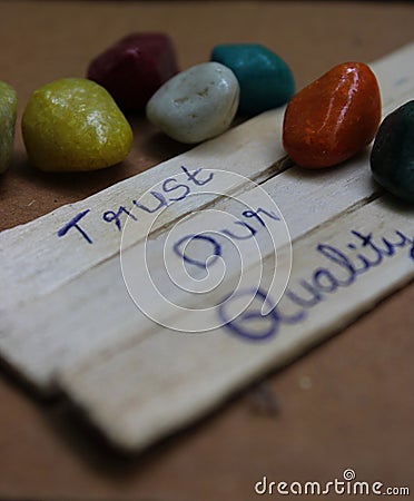 Handwritten inspirational phrase 'Trust our quality' placed in the foreground Stock Photo