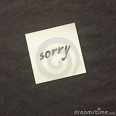 Handwritten note on a dark background. Note of apology- Sorry, p Stock Photo