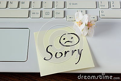 Handwritten note is on the keyboard. - I`m Sorry. Small delicate Stock Photo