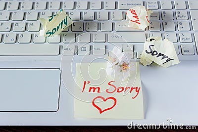 Handwritten note is on the keyboard. - I`m Sorry. Small delicate Stock Photo