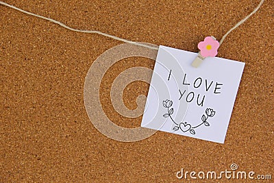 Handwritten note left with pink flowered mandalla on cork board Stock Photo