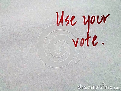 Handwritten red letters on plain background `Use your vote` Stock Photo