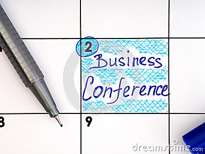Handwritten reminder Business Conference in the calendar with a blue pen Stock Photo