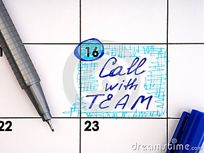 Handwritten reminder Call with Team in the calendar with a blue pen Stock Photo