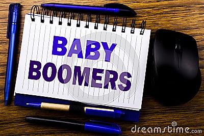 Handwritten text showing Baby Boomers. Business concept for Demographic Generation written on notebook book note paper on the wood Stock Photo