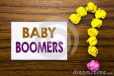 Handwritten text showing Baby Boomers. Business concept for Demographic Generation Written on sticky note paper, wooden background Stock Photo