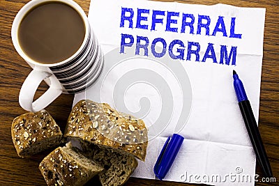 Handwritten text showing Referral Program. Business concept for Refer Marketing written on tissue paper on the wooden background Stock Photo