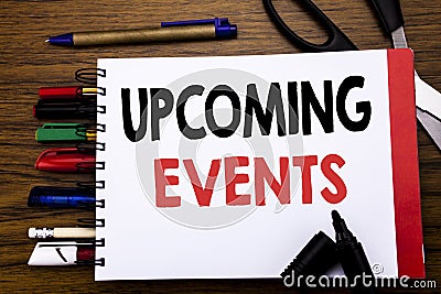 Handwritten text showing Upcoming Events. Business concept for Appointment Agenda List Written on notebook, wooden background with Stock Photo