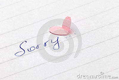 Handwritten word `Sorry` with heart Stock Photo