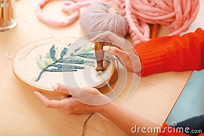 Handy needlewoman stitching beautiful ornament Stock Photo