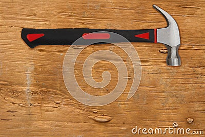 Handyman background with red and black hammer on distressed wood background Stock Photo