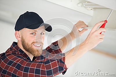 Handyman changing flourescent tube Stock Photo