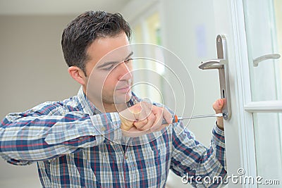 Handyman fitting new door Stock Photo