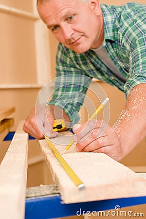 Handyman home improvement close-up of measure wood Stock Photo