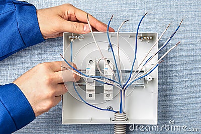 Handyman installs circuit breakers for home wiring Stock Photo