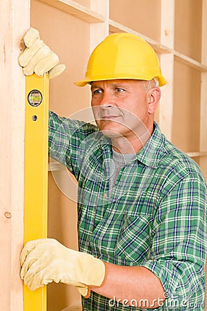 Handyman mature professional with spirit level Stock Photo