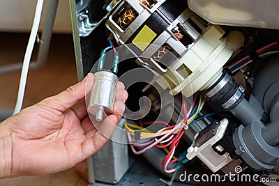 Handyman repairs dishwasher Stock Photo