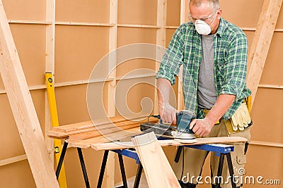 Handyman sanding wooden board diy home renovation Stock Photo