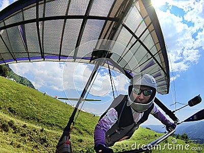 Hang glider pilot after take-off from a hill Stock Photo