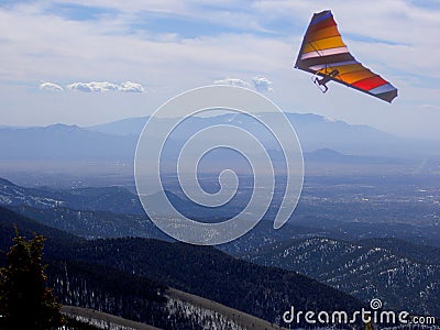 A Hang-Glider Soars the Sangre de Cristo Mountains in New Mexico Stock Photo