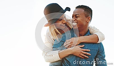 Hang on honey, were going for a ride. a happy young couple enjoying a piggyback ride outdoors. Stock Photo