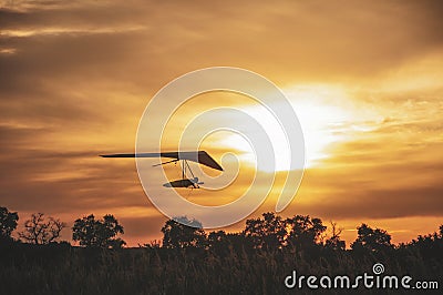 Hangglider silhouette at the sunset Stock Photo