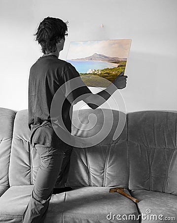 Hanging a colorful painting on blank white wall Stock Photo