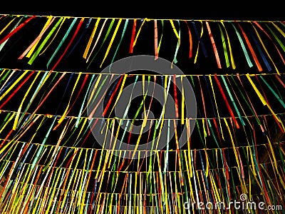 Hanging colorful ribbons swaying in the wind at night for party celebration Stock Photo