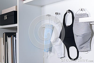 Hanging different medical masks for daily use on the rack. Coronavirus situation. Pandemic crisis Stock Photo