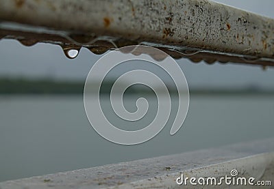 Hanging drops of water on the banisters. Stock Photo