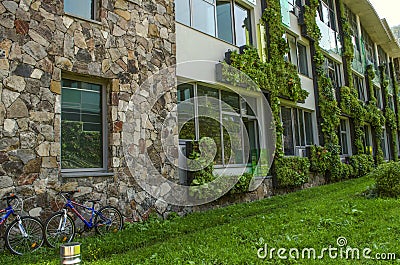 Hanging gardens of climbing plants on the facades of educational buildings of the International College, in Dilijan Editorial Stock Photo