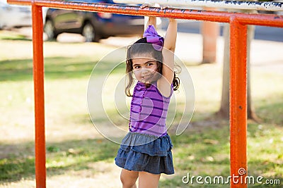 Hanging from handlebars and smiling Stock Photo