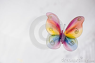 Hanging handmade butterfly in rainbow colors for venue decor or ornament Stock Photo