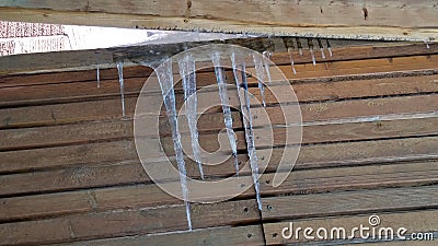 Hanging icycles from the roof frames Stock Photo