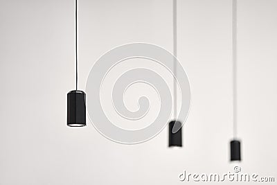 Hanging illuminated dark lamps on blurred background Stock Photo