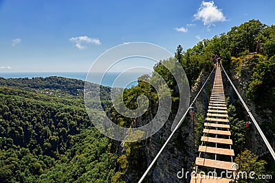 Hanging ladder over a precipice in the mountains, copy space. Stock Photo