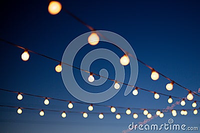 Hanging lights at night Stock Photo