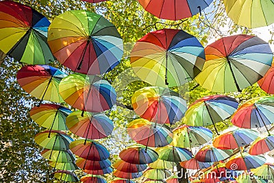 Hanging rainbow umbrellas in the sky during the gay pride in the Marais district of Paris, France Editorial Stock Photo