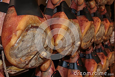 Hanging Raw Parma Ham Legs in Shop Stock Photo