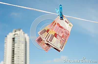 Hanging on the rope Indonesian banknotes rupiah Stock Photo