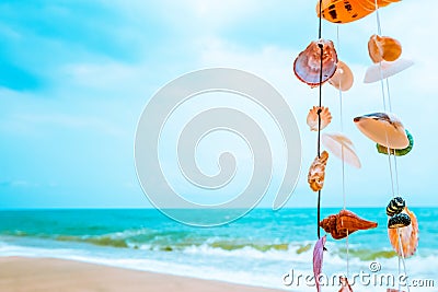 Hanging seashells decoration with tropical beach Stock Photo