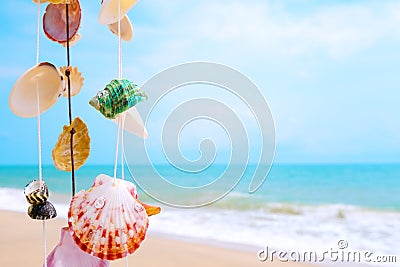 Hanging seashells decoration with tropical beach Stock Photo