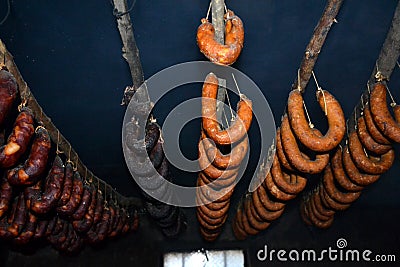 Hanging traditional saussages on smokehouse Stock Photo