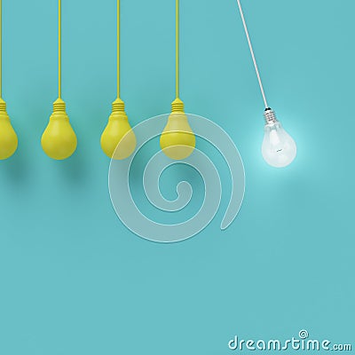 Hanging yellow light bulbs with glowing one different idea on light blue background Stock Photo